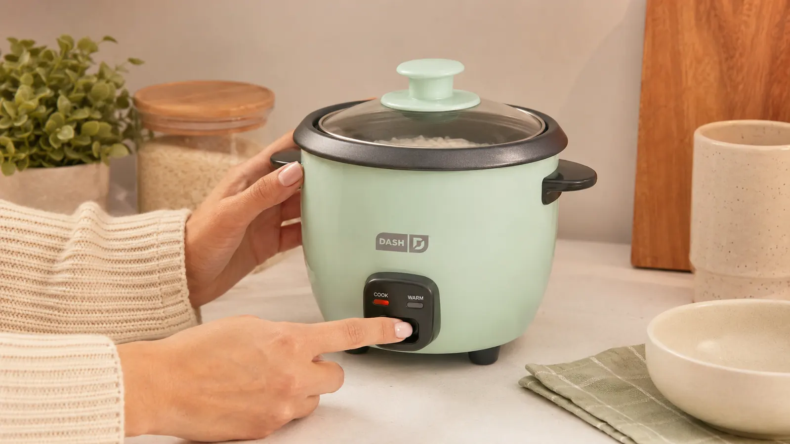 Finished bowl of cooked brown rice scooped from the Dash Mini rice cooker with a wooden spoon